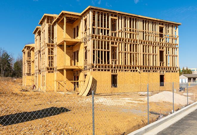 a temporary chain link fence winding around a construction site, outlining the project's progress in Coachella, CA